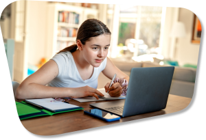 teenager studying at home on a laptop