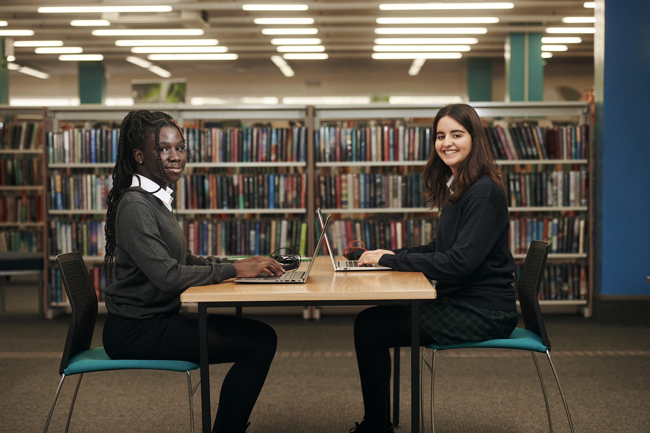 Two students sitting at a table in their classroom