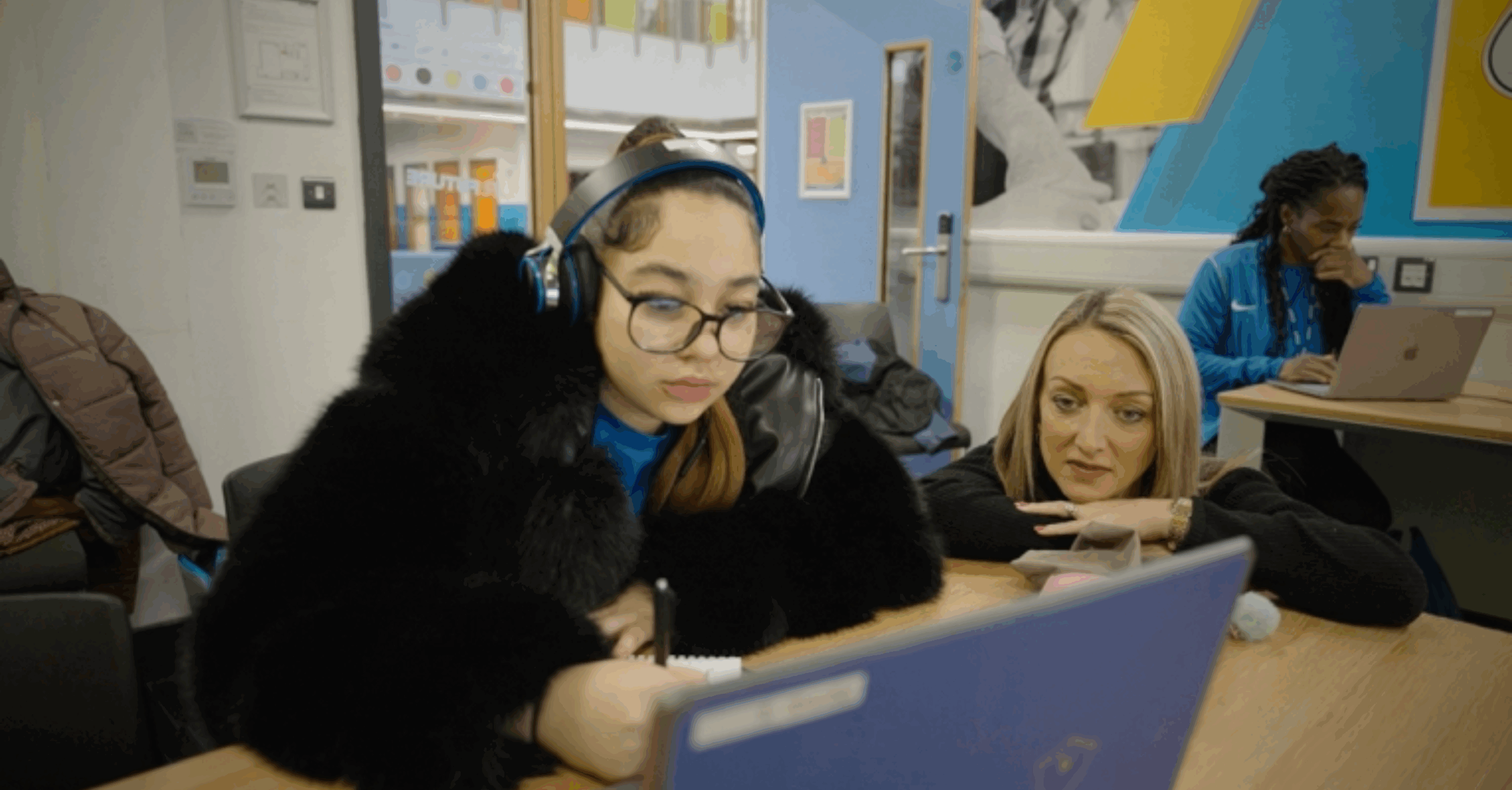 A student, Shantay, participates in a live online Academy21 lesson at Evolution Sports, supported by a teacher-mentor.